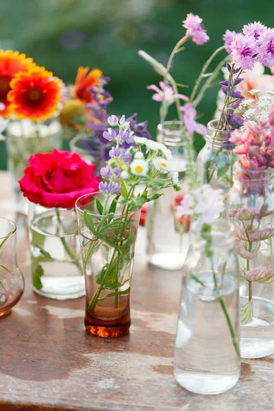 Nice flowers in bottles — Stock Photo, Image