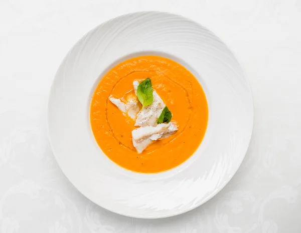 Cream soup with fish on  plate — Stock Photo, Image