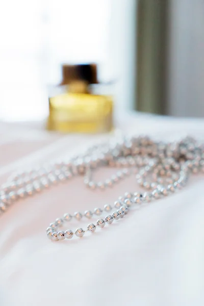 Collar de perlas en la cama — Foto de Stock