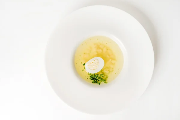 Бульон с яйцом в тарелке — стоковое фото