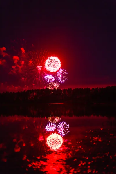 Bright fireworks over river — Stock Photo, Image