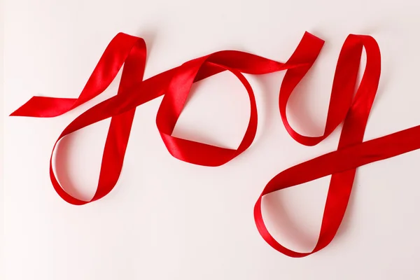 Joy written with red ribbon — Stock Photo, Image