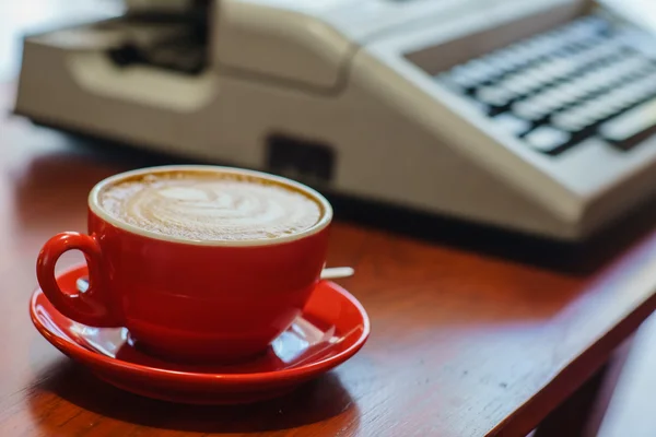 Red cup of cappuccion — Stock Photo, Image