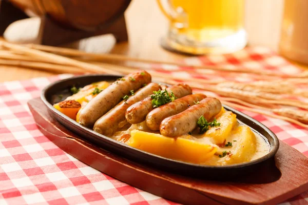 Roasted potatoes with sausages — Stock Photo, Image