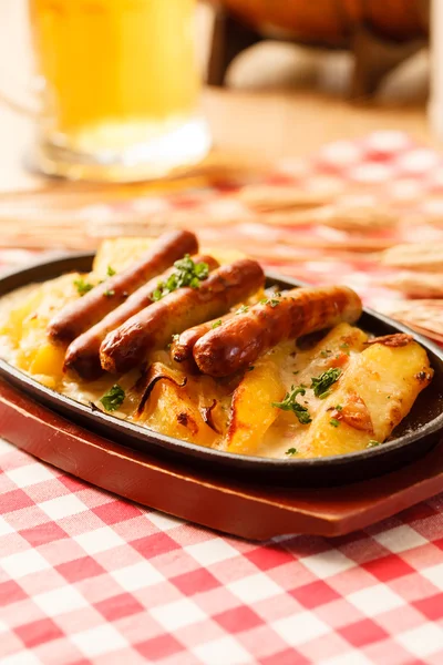 Roasted potatoes with sausages — Stock Photo, Image