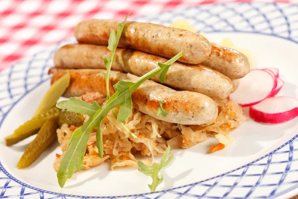 Sausages with cabbage on plate — Stock Photo, Image