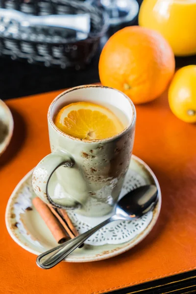 Orange tea in mug — Stock Photo, Image