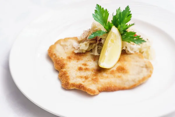 Schnitzel served with cabbage — Stock Photo, Image