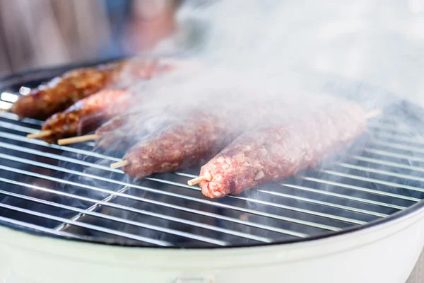 Grilling kebabs on a grate — Stock Photo, Image