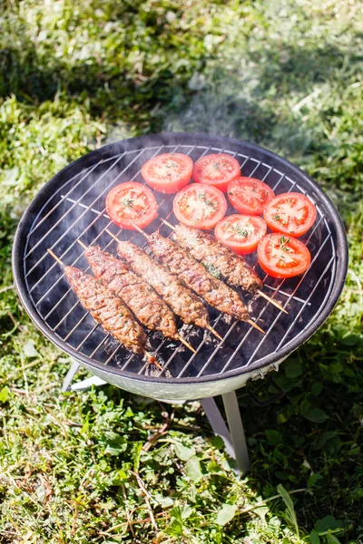 Grilling kebabs outdoors — Stock Photo, Image