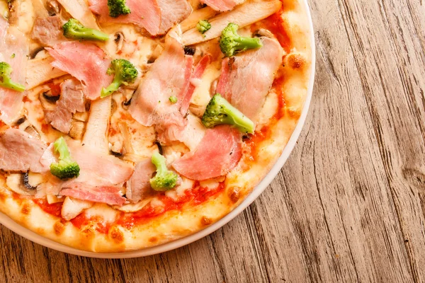 Pizza op houten ondergrond — Stockfoto