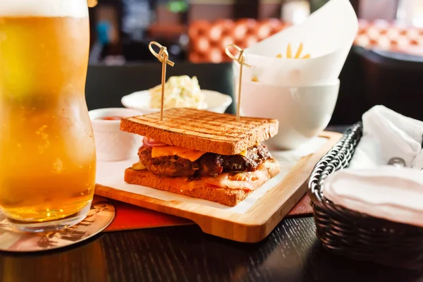 Delicious sandwich with beer — Stock Photo, Image