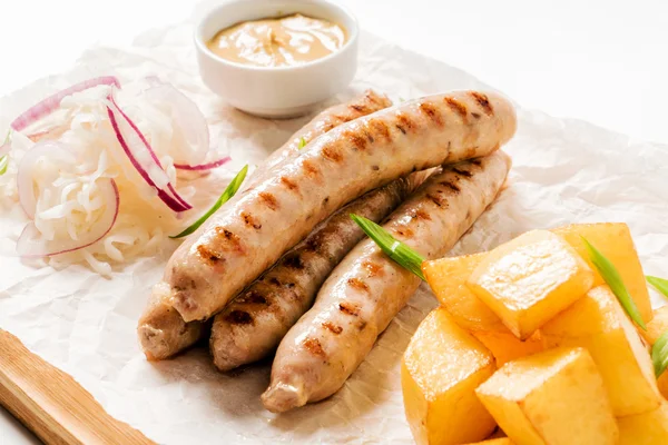 Sausages with potatoes on plate — Stock Photo, Image