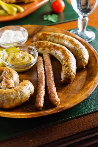 Sausages with sauce on plate — Stock Photo, Image