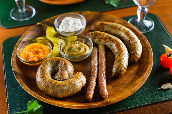 Grilled sausages with sauces — Stock Photo, Image