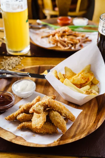 Chicken nuggets with potatoes — Stock Photo, Image