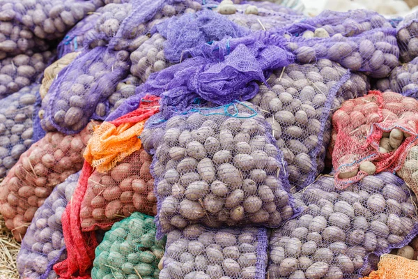 Potatoes in bags at market — Stock Photo, Image