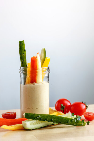 Hummus with vegetables in jar