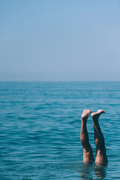 Legs lifted above water — Stock Photo, Image
