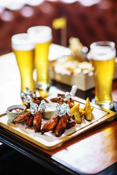 Beer and snacks on table — Stock Photo, Image