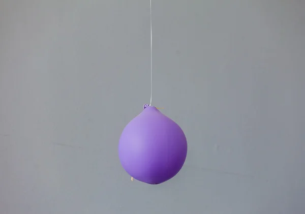 Deflated purple balloon