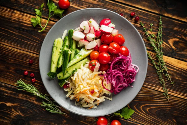 fermented vegetables on the wooden background