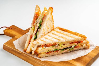 Jambon, peynir, domates, marul ve kızarmış ekmek ile sandviç.