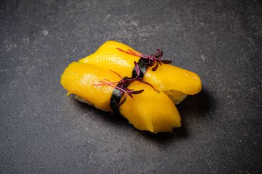 sushi with mango  on the stone