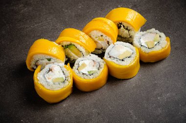 sushi with mango  on the stone