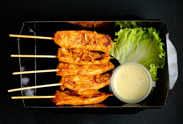 chicken kebab with sauce in the box