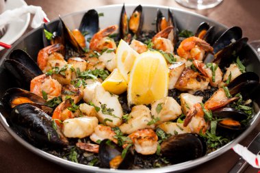 Seafood paella in the fry pan clipart