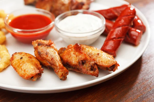 Appetizer plate with dipping sauces — Stock Photo, Image