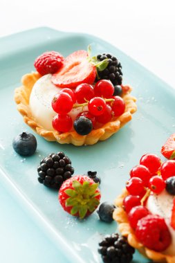 Berries tarts on plate clipart