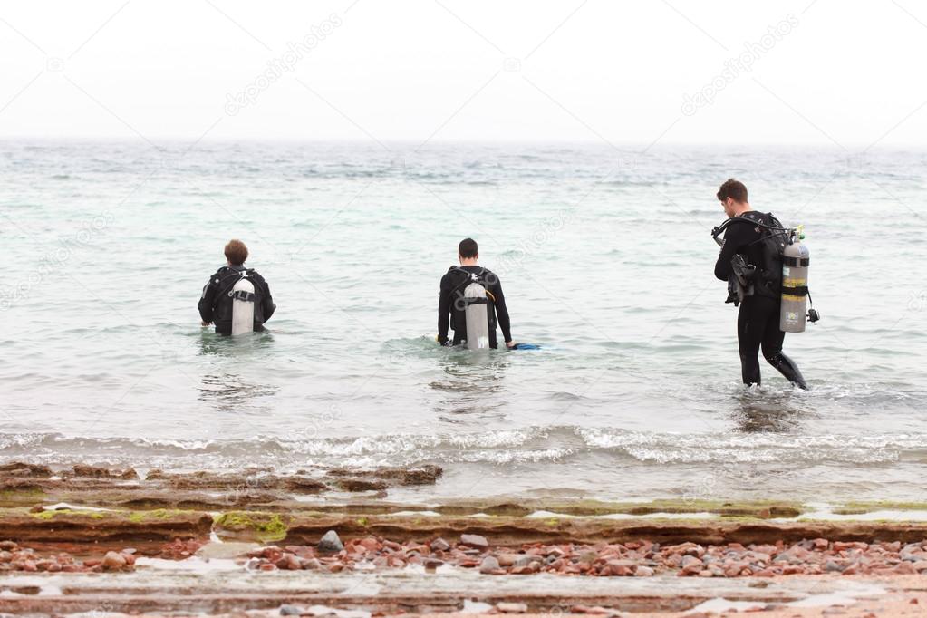 Divers on the beach of Red Sea