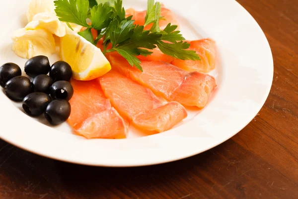 Aperitivo de salmón con limón y aceitunas — Foto de Stock