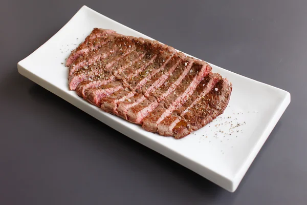 Juicy steak on dish — Stock Photo, Image