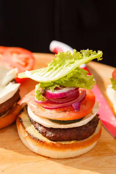 Burger on wooden table — Stock Photo, Image