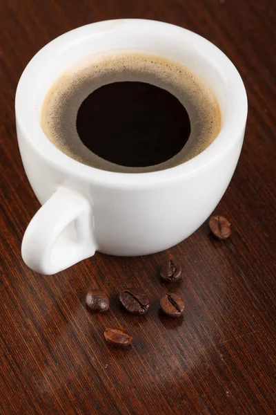 Cup of coffee with beans — Stock Photo, Image