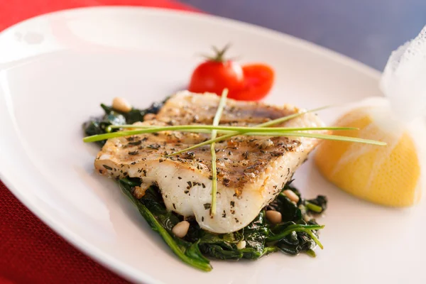 White fish with spinach Royalty Free Stock Images