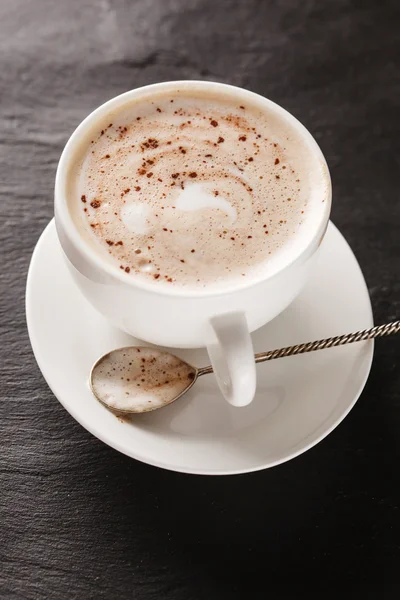 Cup of cappuccino on saucer — Stock Photo, Image