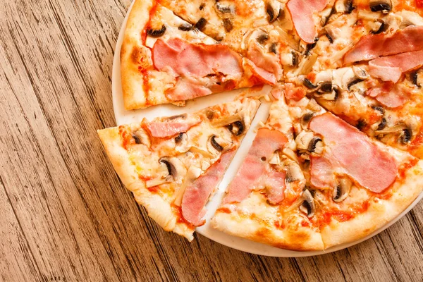 Pizza on wooden background — Stock Photo, Image