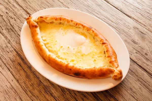 Ajarian khachapuri  on dish — Stock Photo, Image