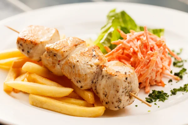 Chicken kebab with french fries — Stock Photo, Image