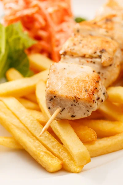 Chicken kebab with french fries Royalty Free Stock Images