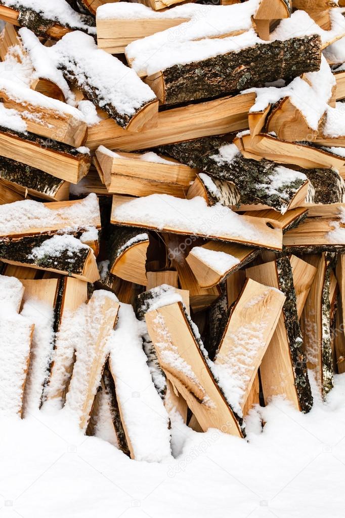 firewood covered by snow