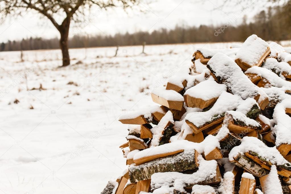 firewood covered by snow