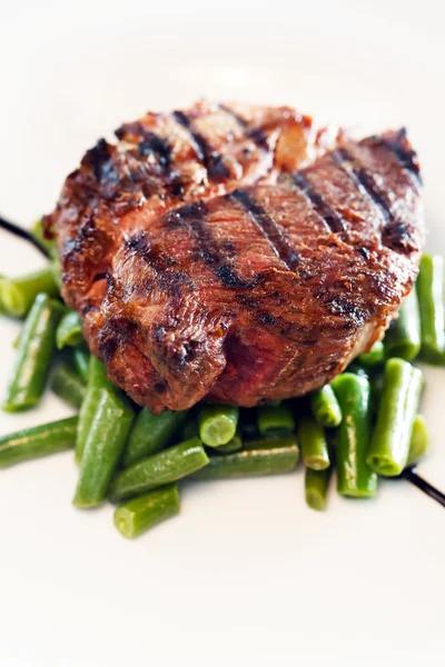 Steak with beans on white — Stock Photo, Image