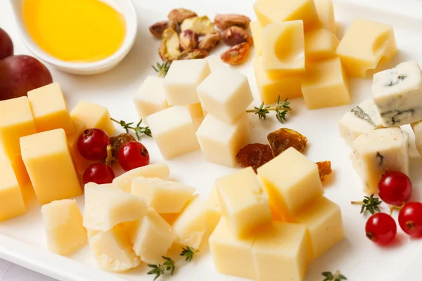 Cheese plate with snacks — Stock Photo, Image