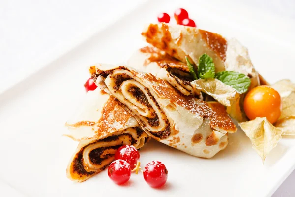 Pancakes with chocolate and berries — Stock Photo, Image