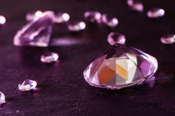 Different diamonds with purple light — Stock Photo, Image
